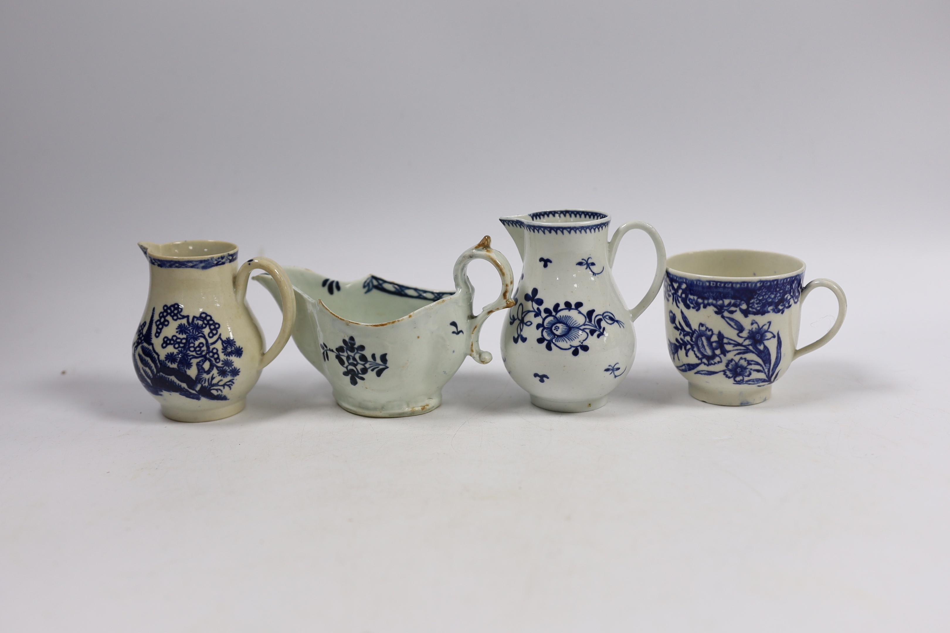 Christian or Pennington, Liverpool porcelain - a sauceboat, two milk jugs and a coffee cup, largest 13cm wide